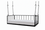 Black metal swing bed with white mattress on a white background